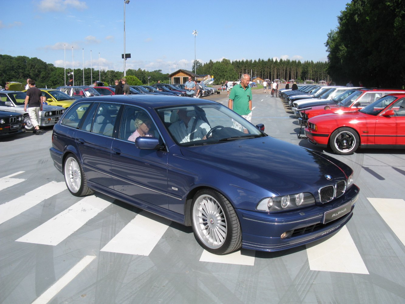Blue performance touring wagon with multi-spoke Alpina wheels and sporty front bumper