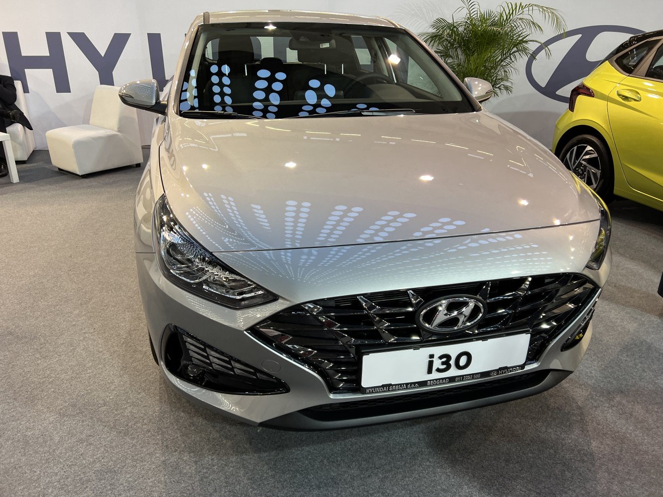 Front view showing sleek headlamps and prominent black grille