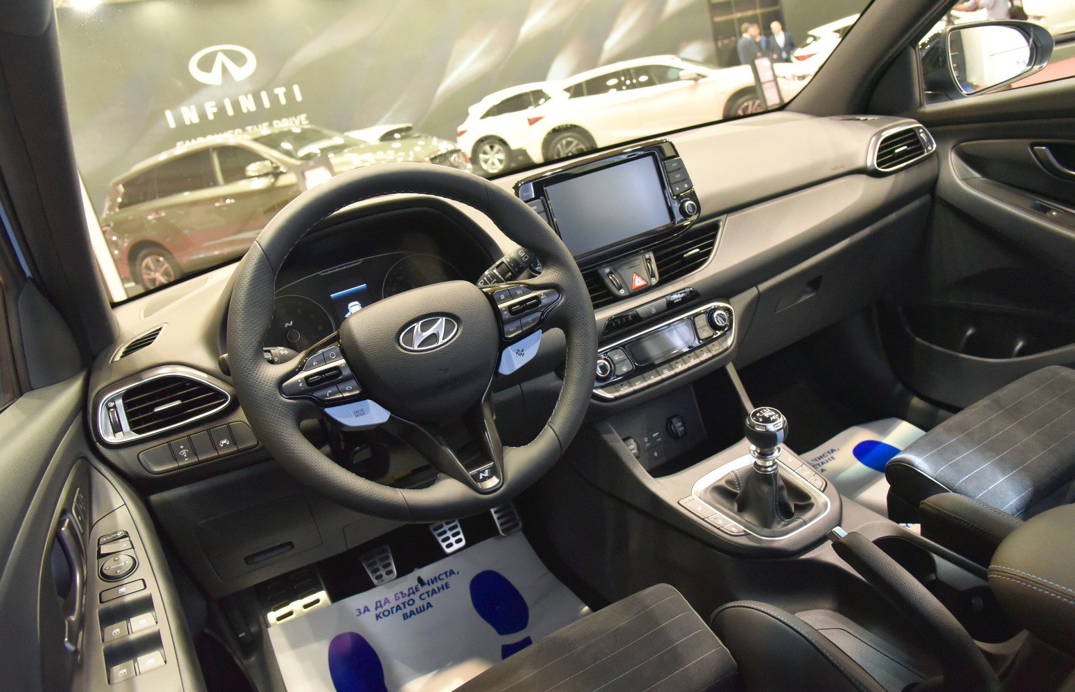 Dashboard, steering wheel with controls, manual gear shift, car interior layout