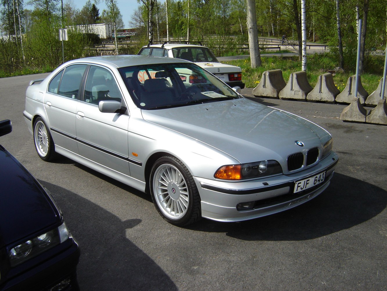 Silver sedan with classic multi-spoke wheels and sleek body design