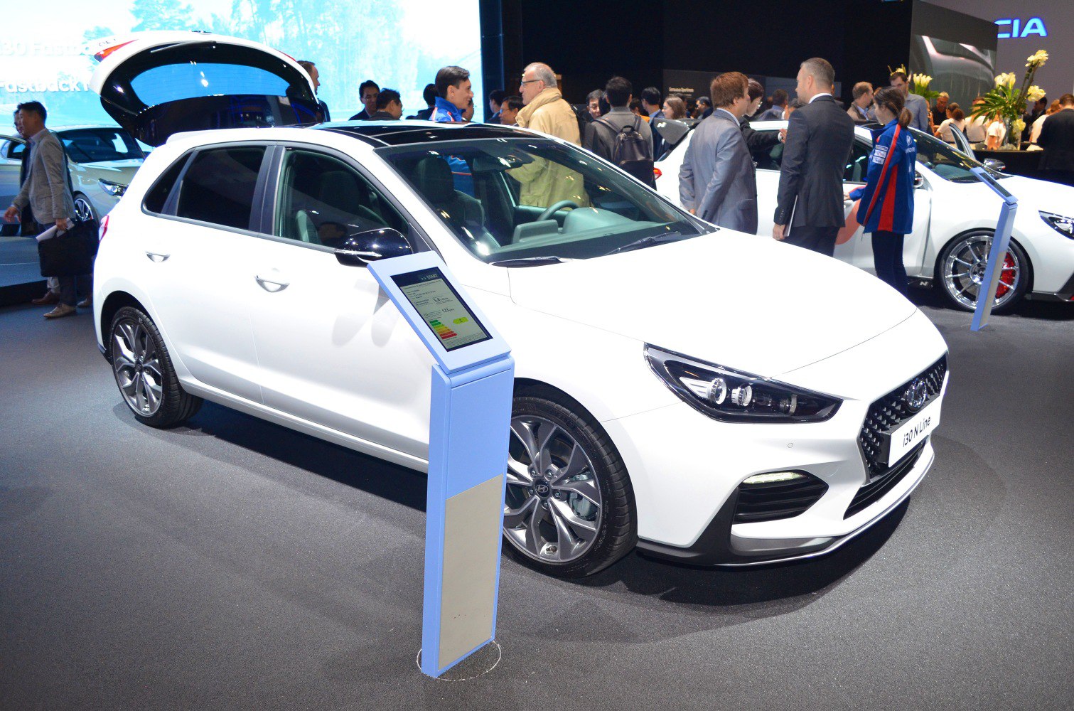 White hatchback car front with sharp headlights and alloy wheels