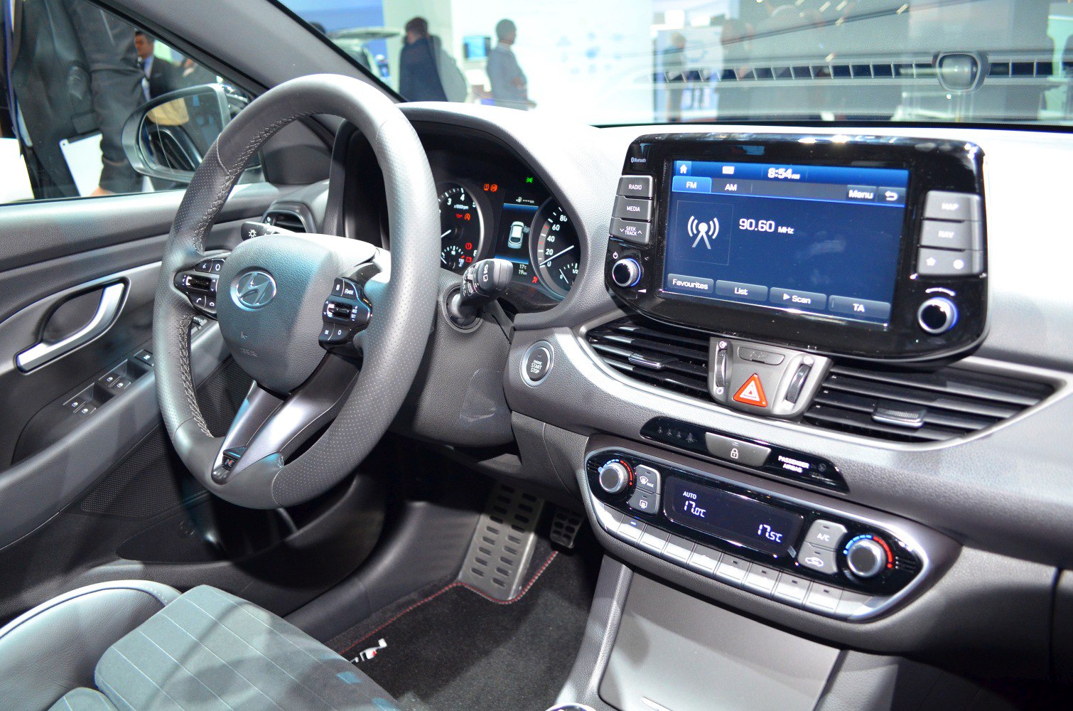 Dashboard with infotainment screen and ergonomic steering wheel with controls.