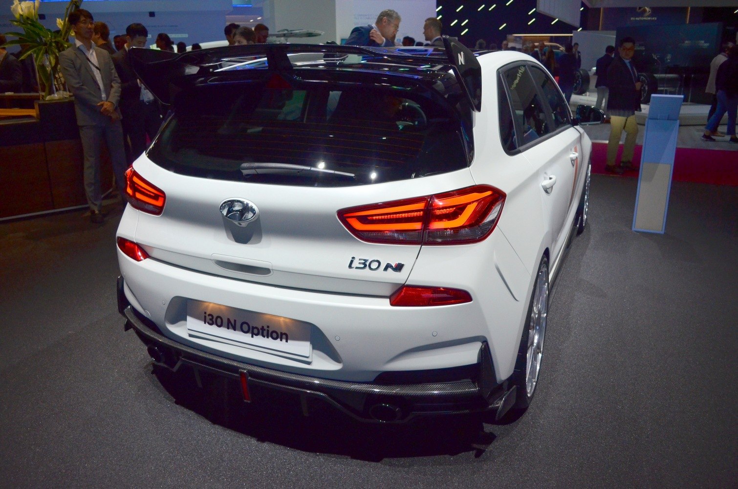 Rear view with N Option spoiler and illuminated rear lights.