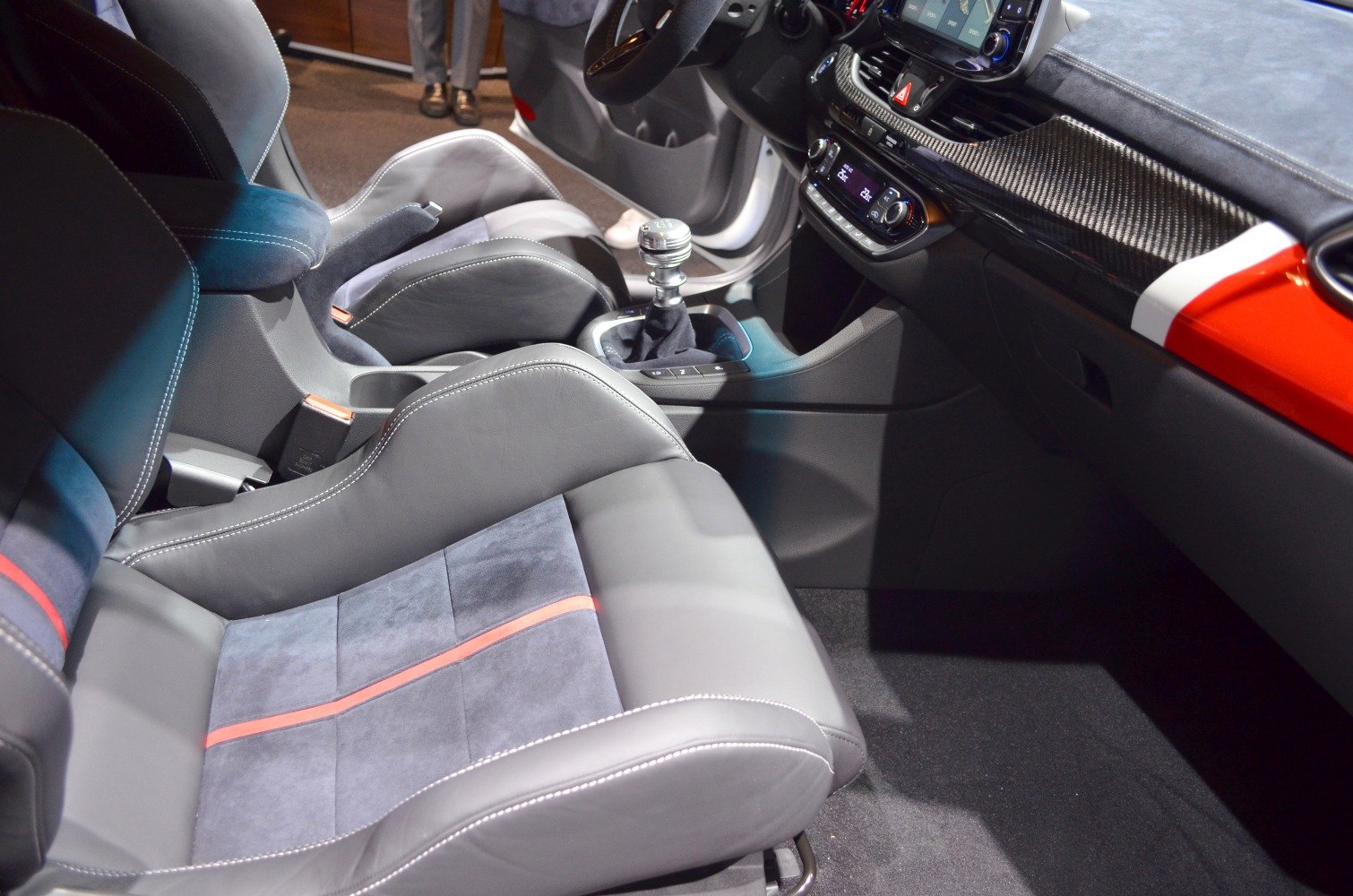 Sports seats with red stripe and manual gear shift lever