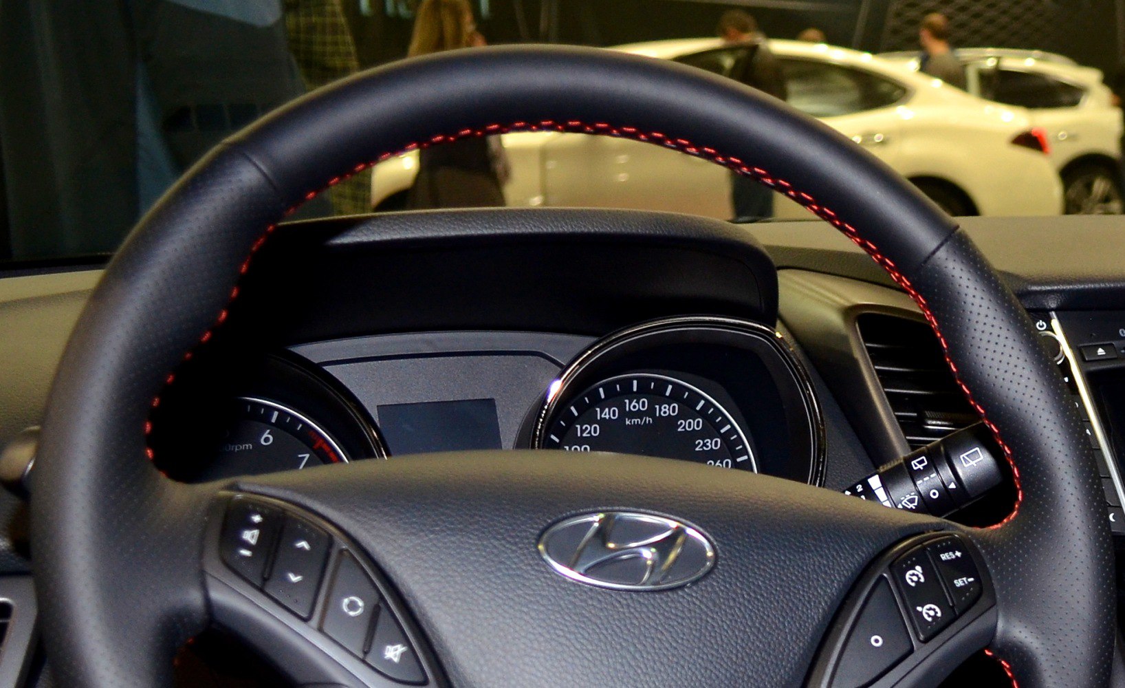 Steering wheel with control buttons and dashboard gauges