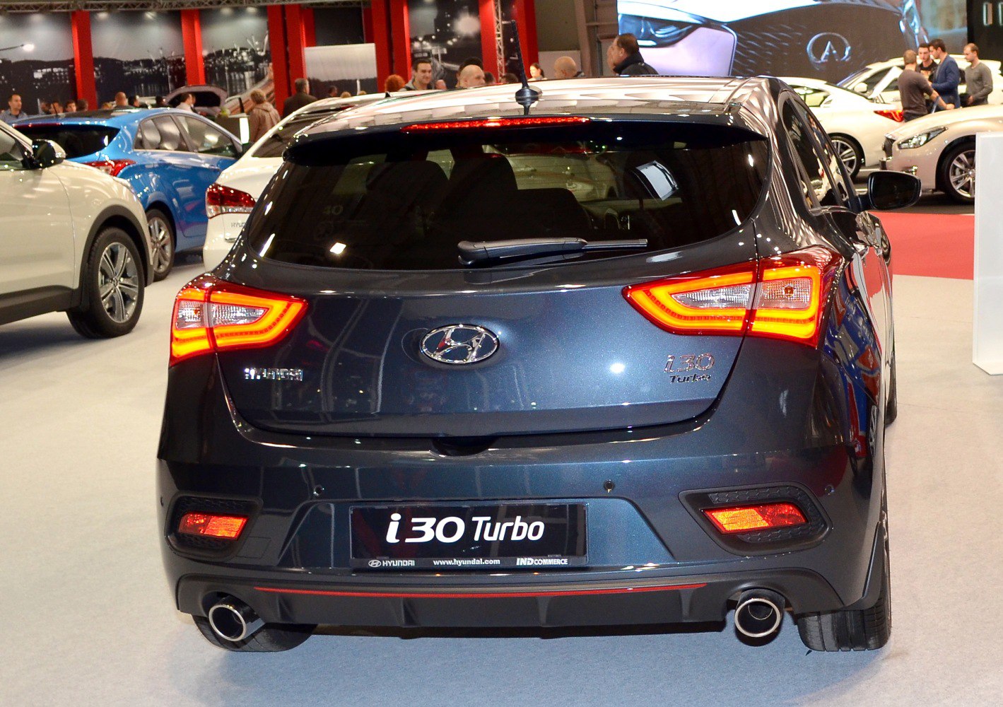 Rear view of turbo hatchback with distinctive tail lights and dual exhausts