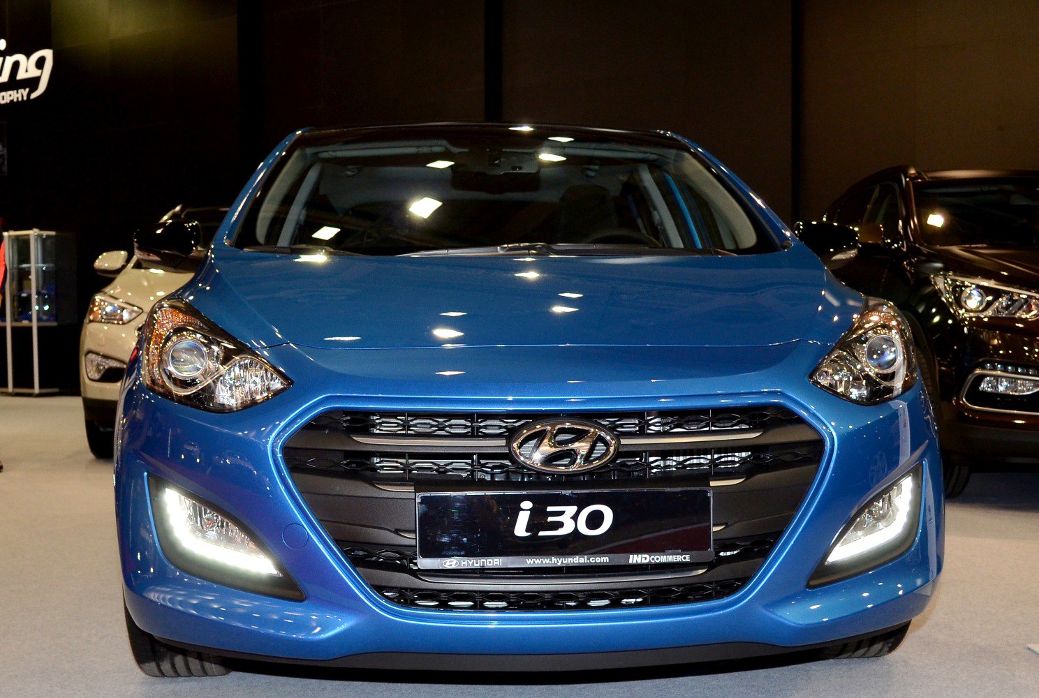 Front view of a car with LED daytime running lights and distinctive grille design.