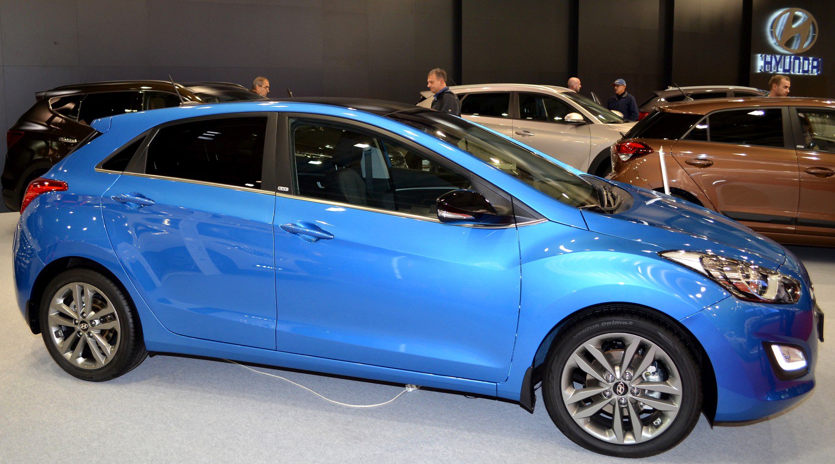 Blue modern hatchback car side profile with alloy wheels