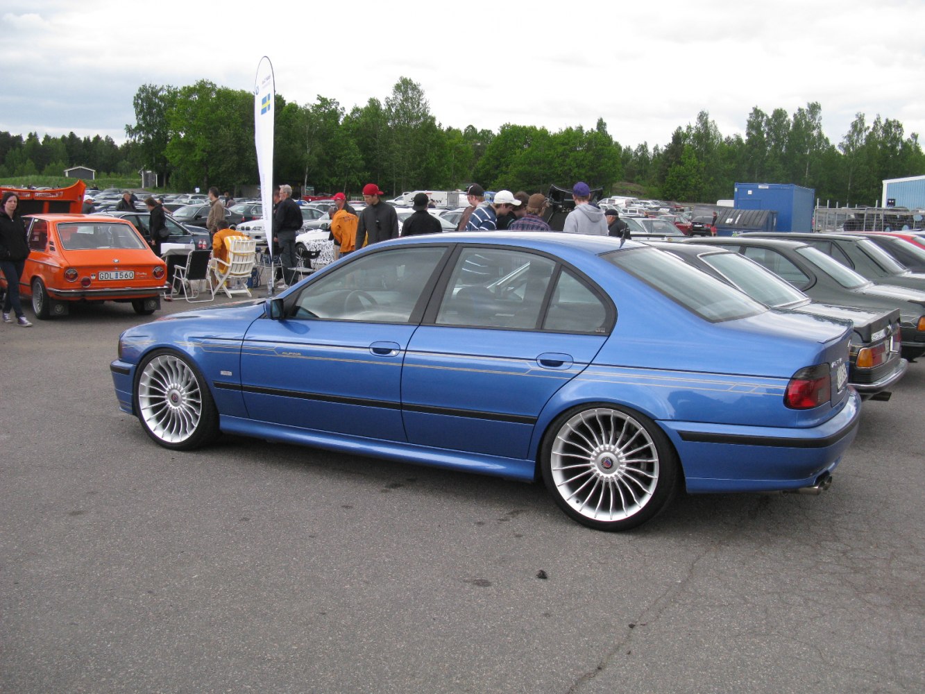 Blue luxury sedan with multi-spoke alloy wheels