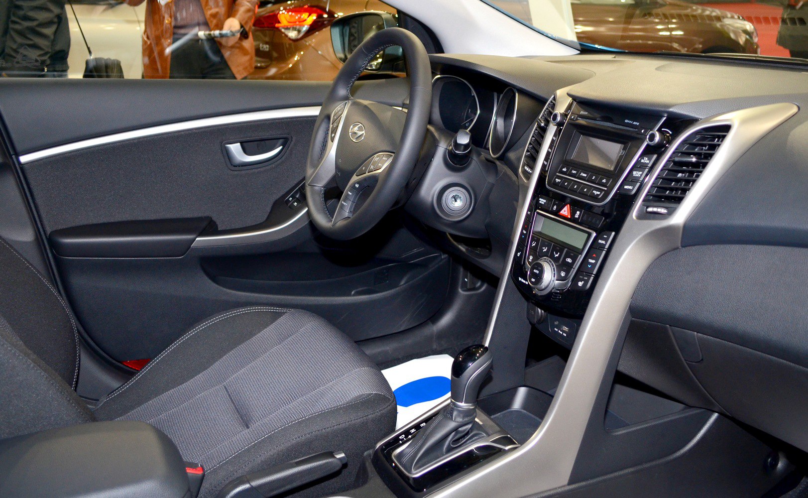 Dashboard, steering wheel, and center console with gear shift and controls