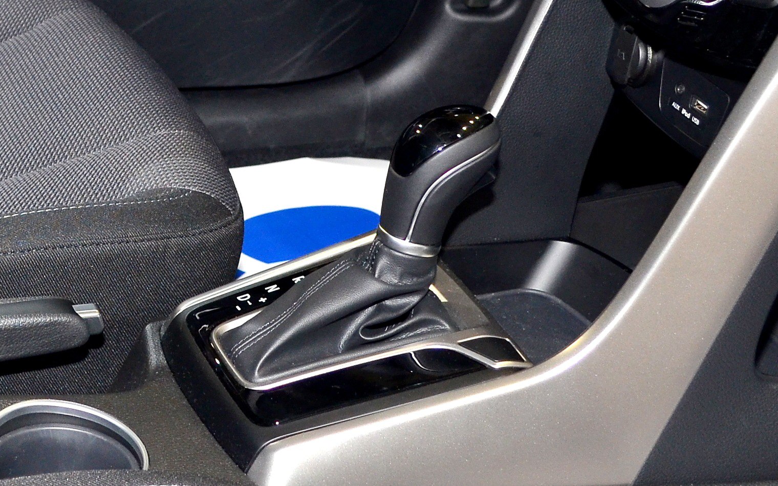 Automatic gear shift lever and center console close-up.