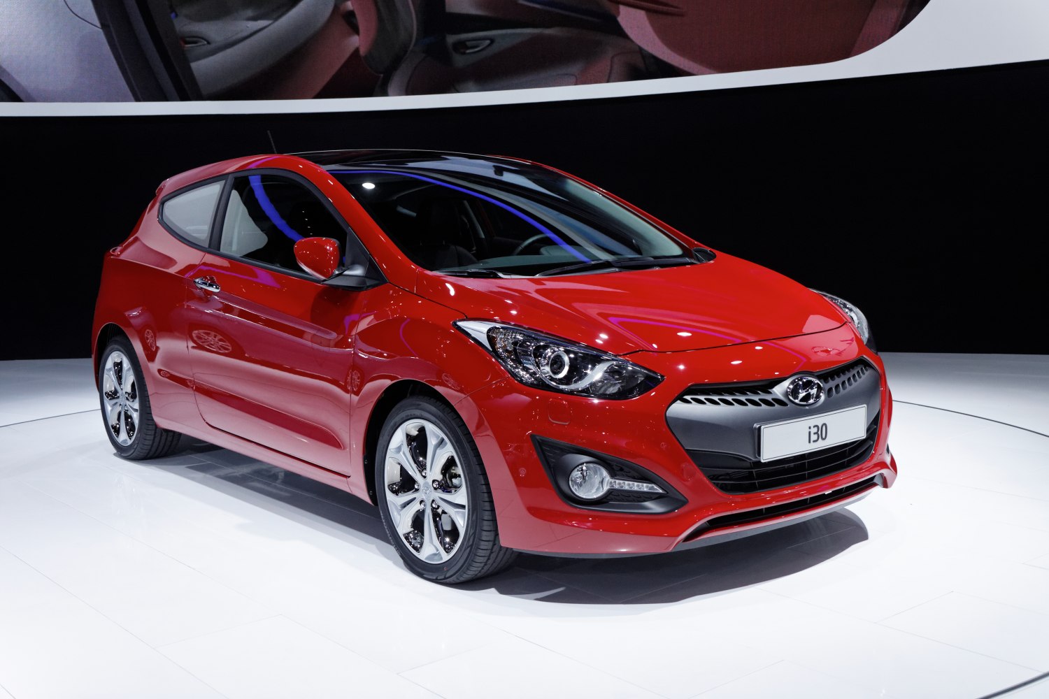 Red compact hatchback with modern headlights and sporty design