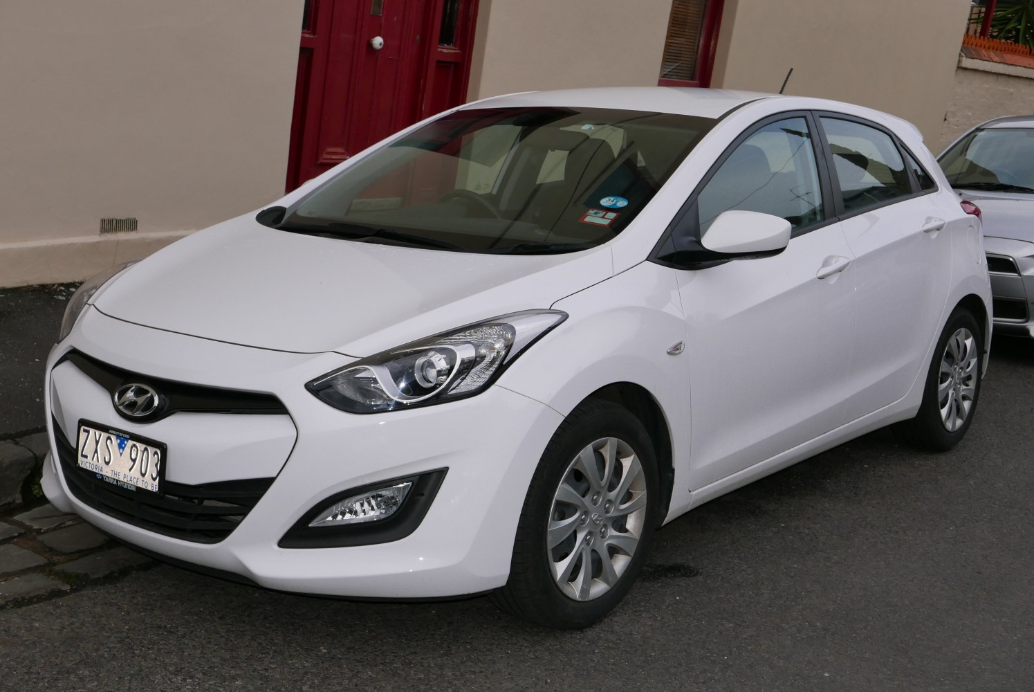 Front and side view with modern headlights and aerodynamic design