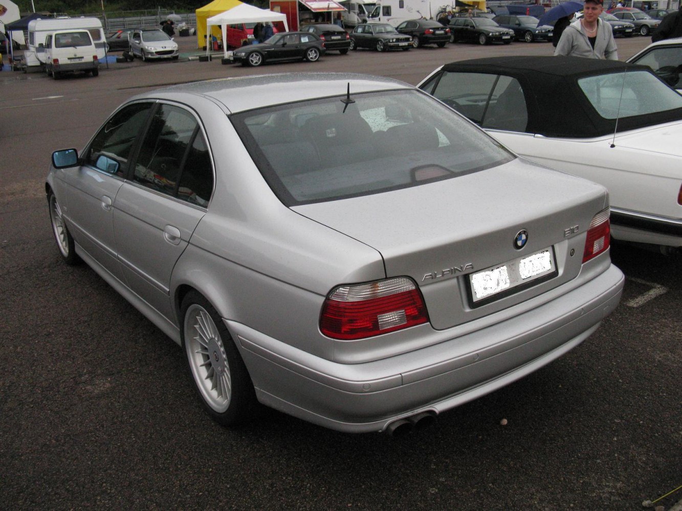 Rear view of luxury sedan with multi-spoke alloy wheels