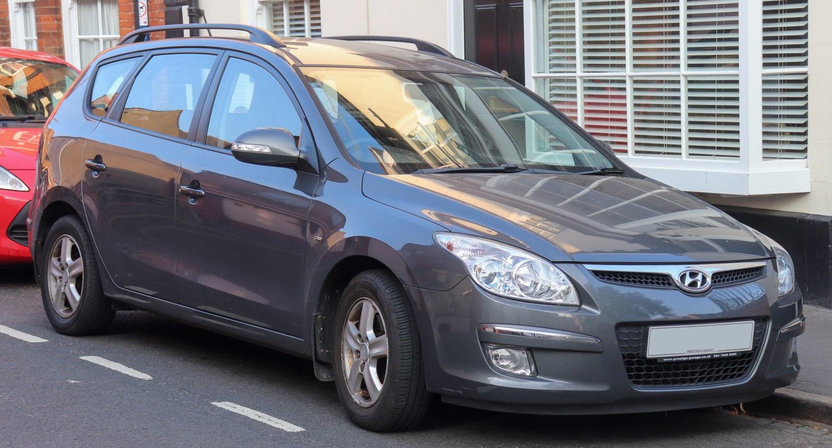 Gray station wagon with front side view, headlights, and grille