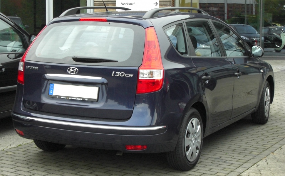 Compact station wagon rear with tall vertical tail lights and roof rails