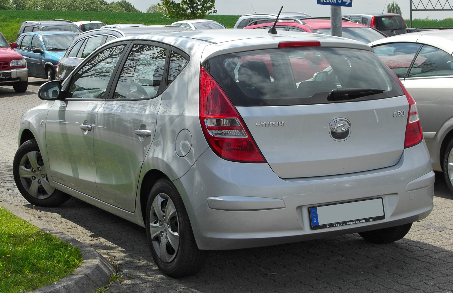 Silver hatchback rear view with distinctive taillights and rear window wiper