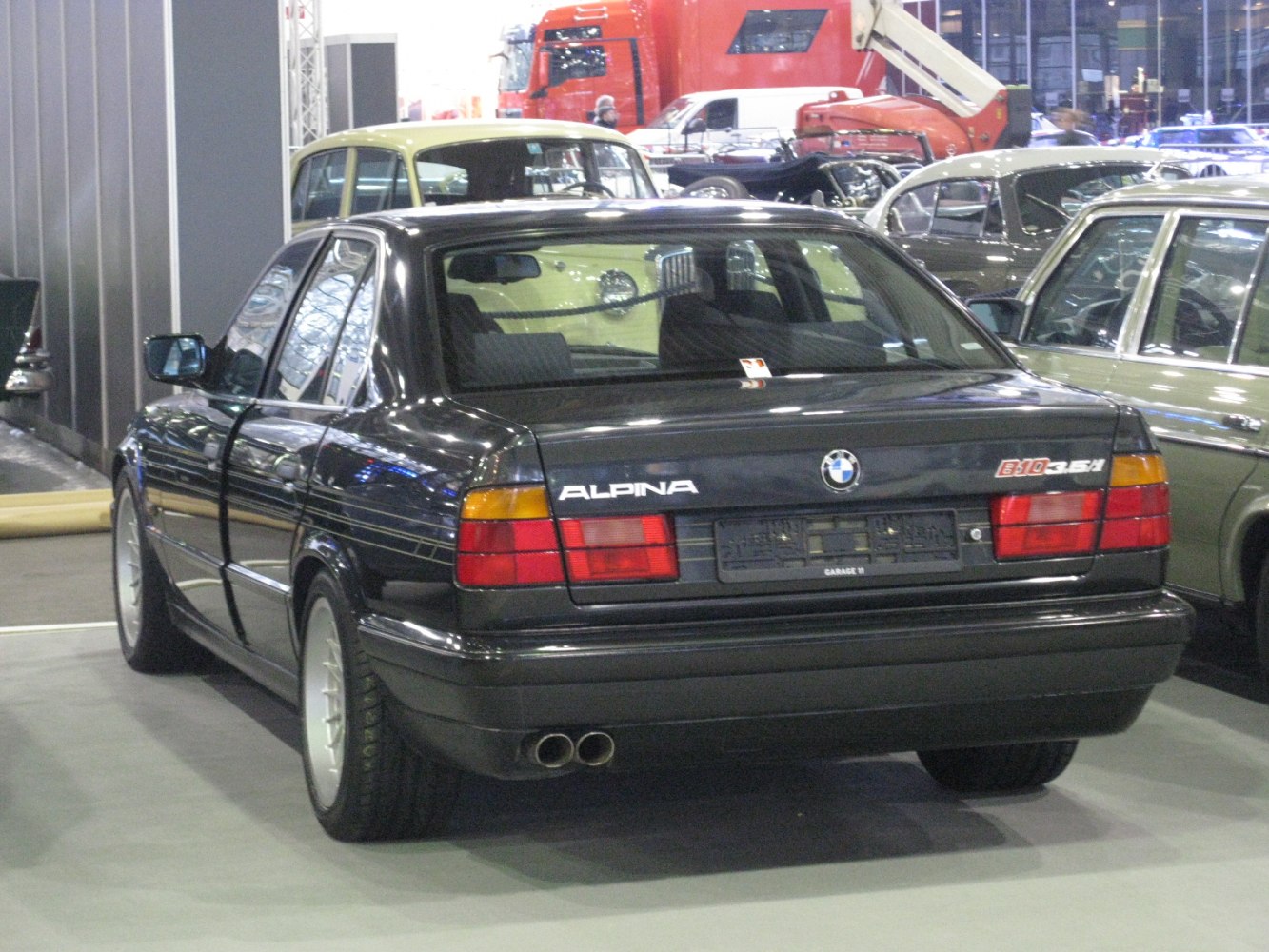 Rear view of a sedan with distinctive tail lights and dual exhaust pipes.