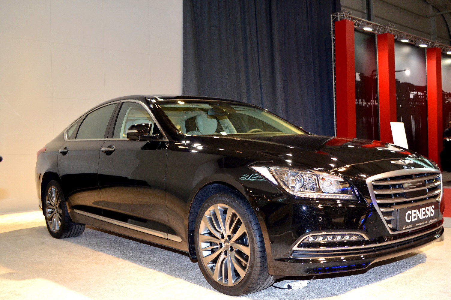 Luxury black sedan with LED headlights and prominent chrome grille