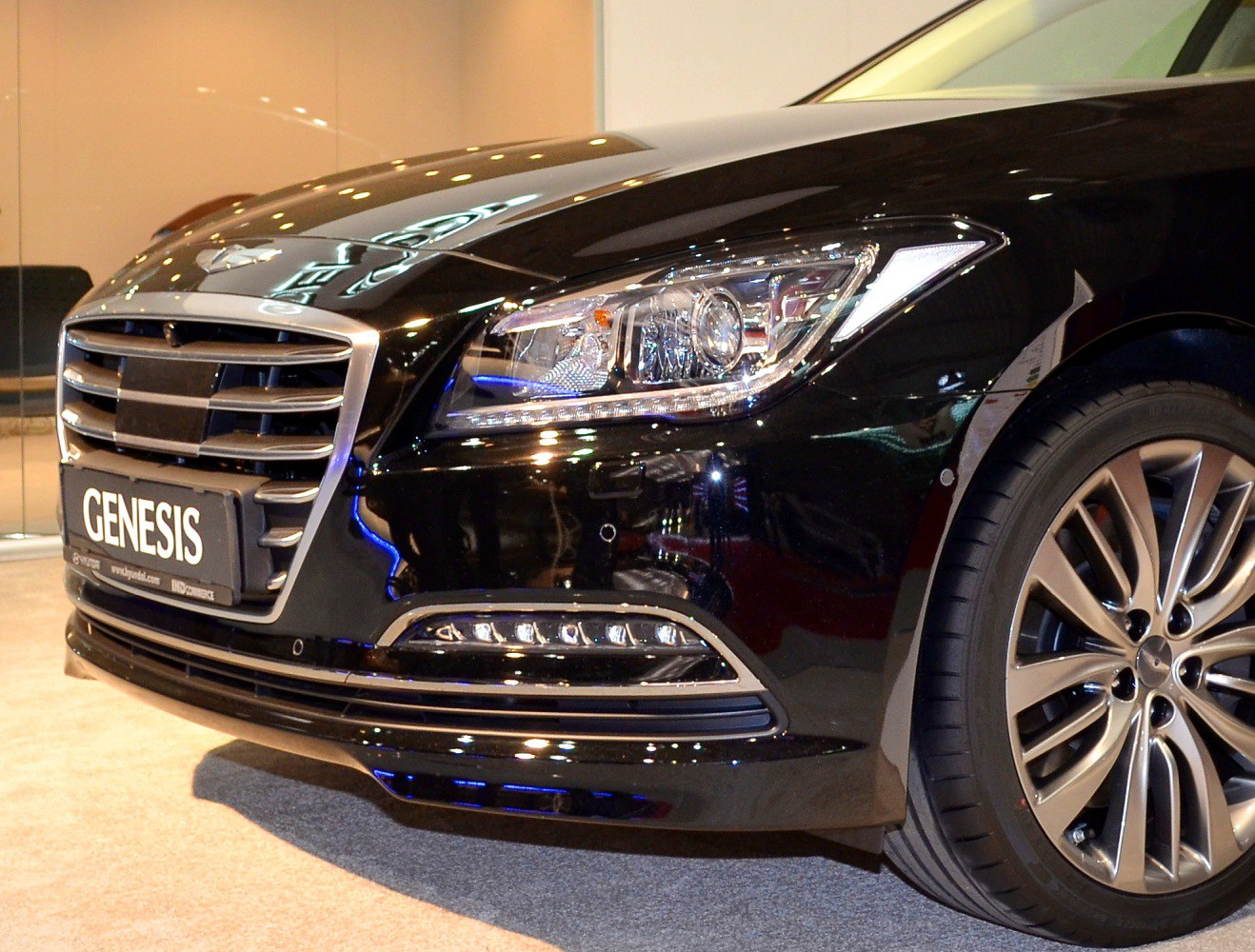 Front grille, headlight, and alloy wheel close-up