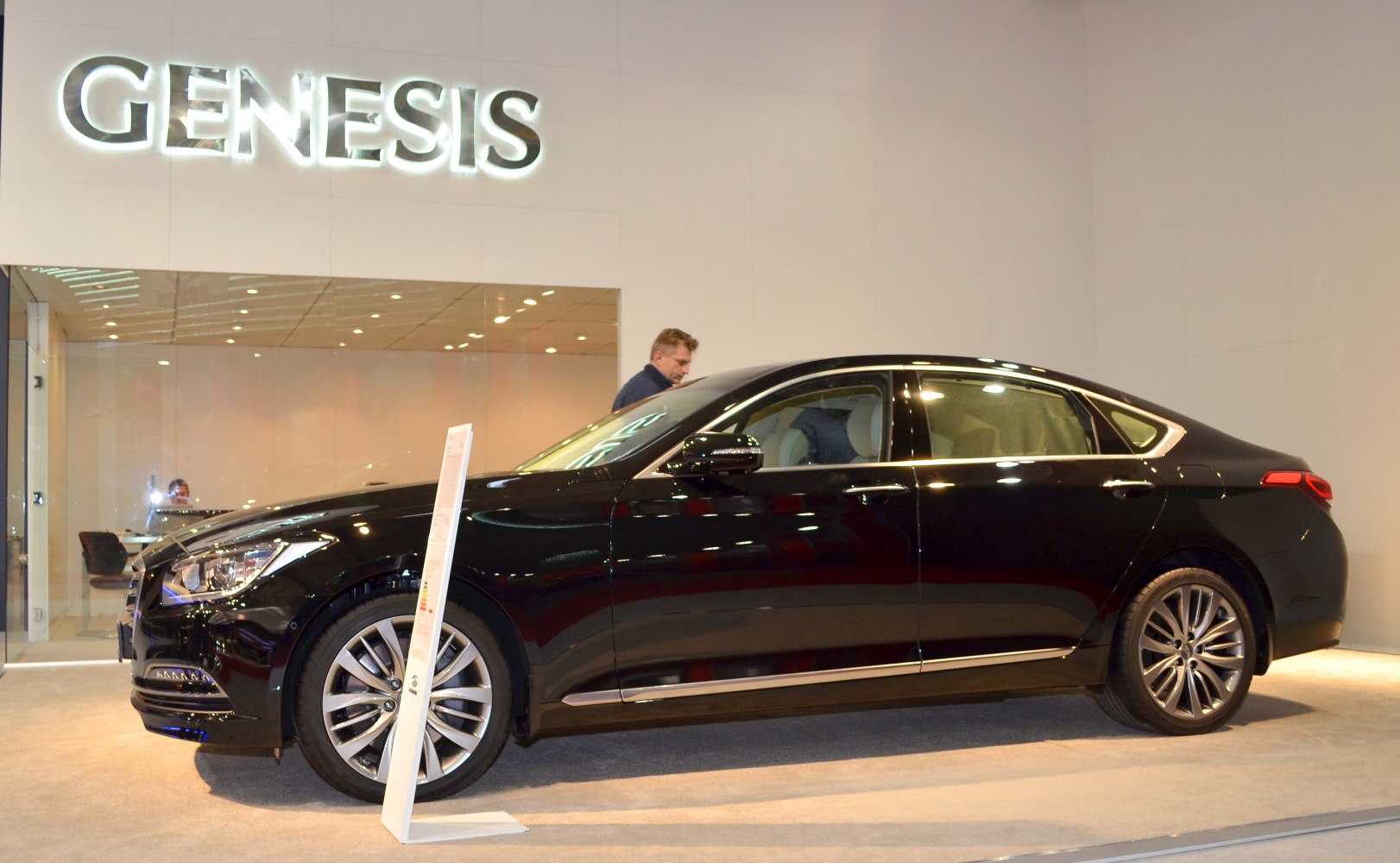 Side profile of luxury sedan with sleek design and alloy wheels