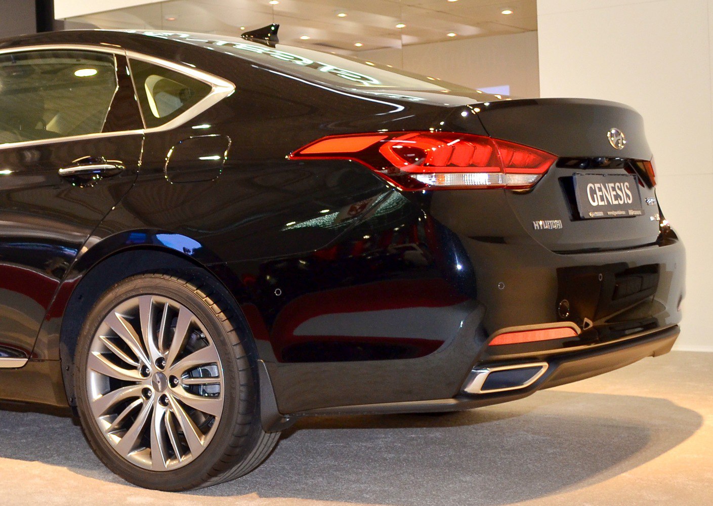 Rear end with taillights and alloy wheels