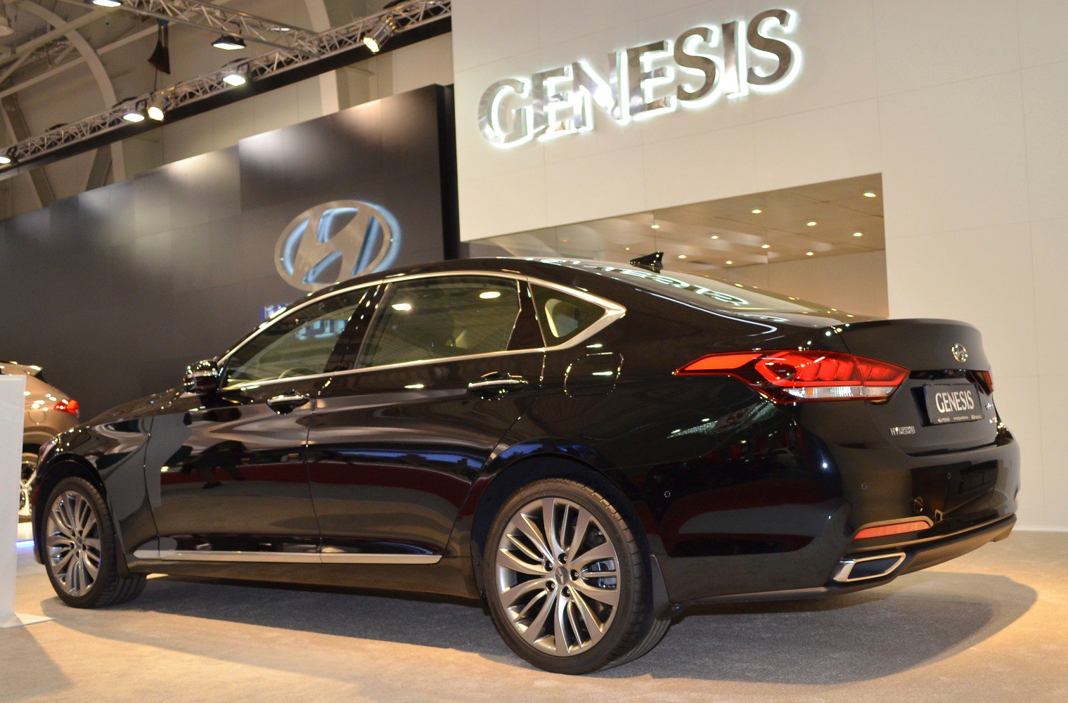 Rear side view of sleek black luxury sedan with alloy wheels