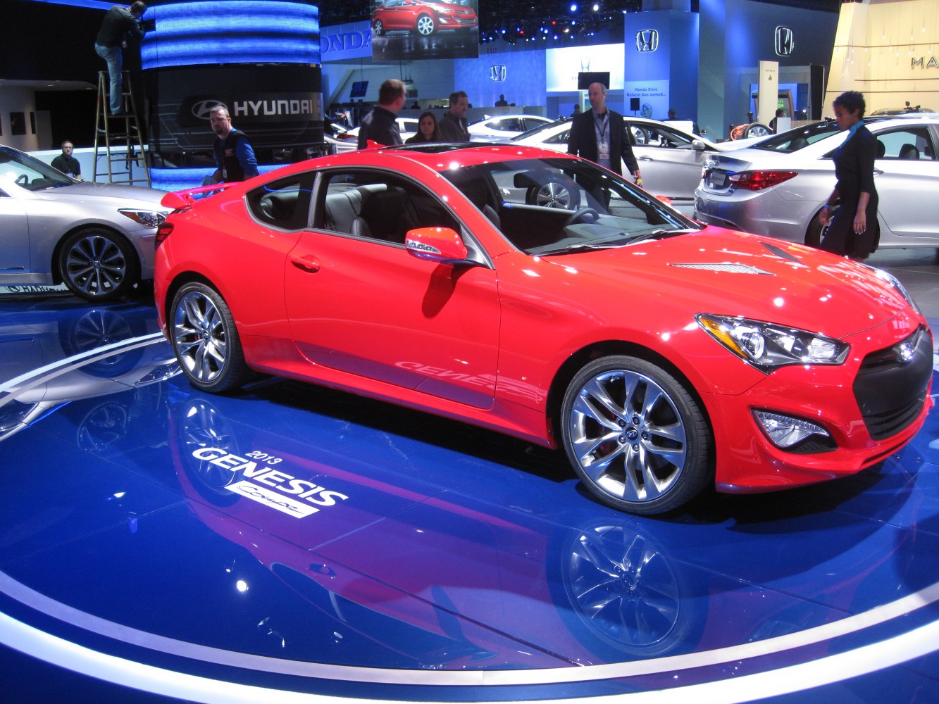 Red sporty coupe with alloy wheels and modern headlights