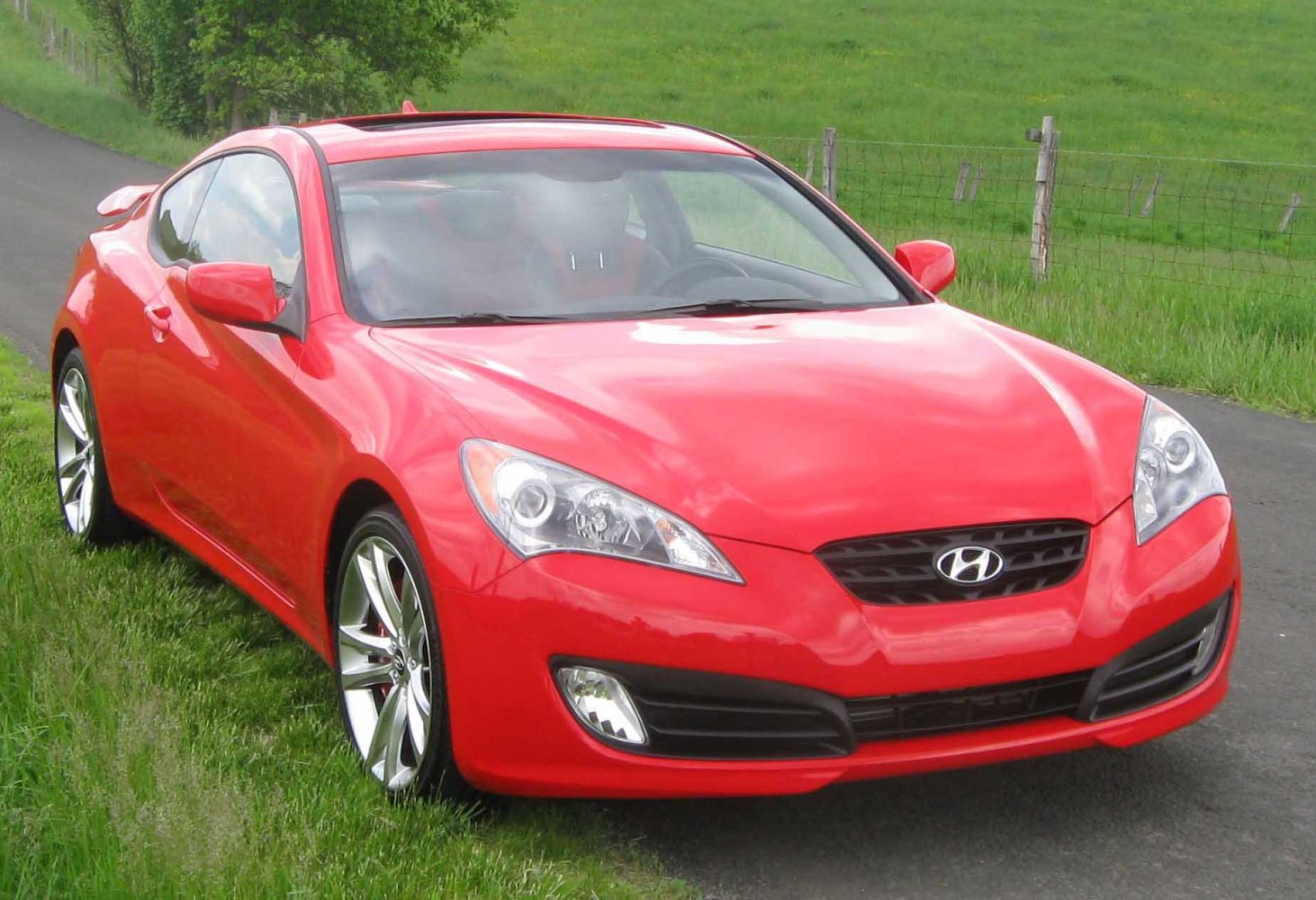 Front view of sporty car with sleek headlights and alloy wheels