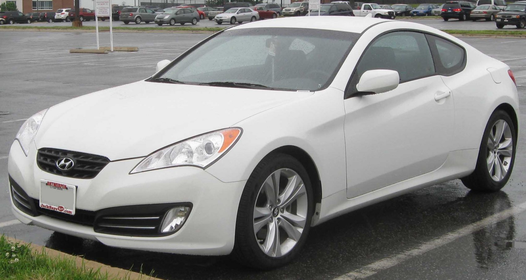 Front side view of a sleek sporty coupe with distinctive headlights and alloy wheels