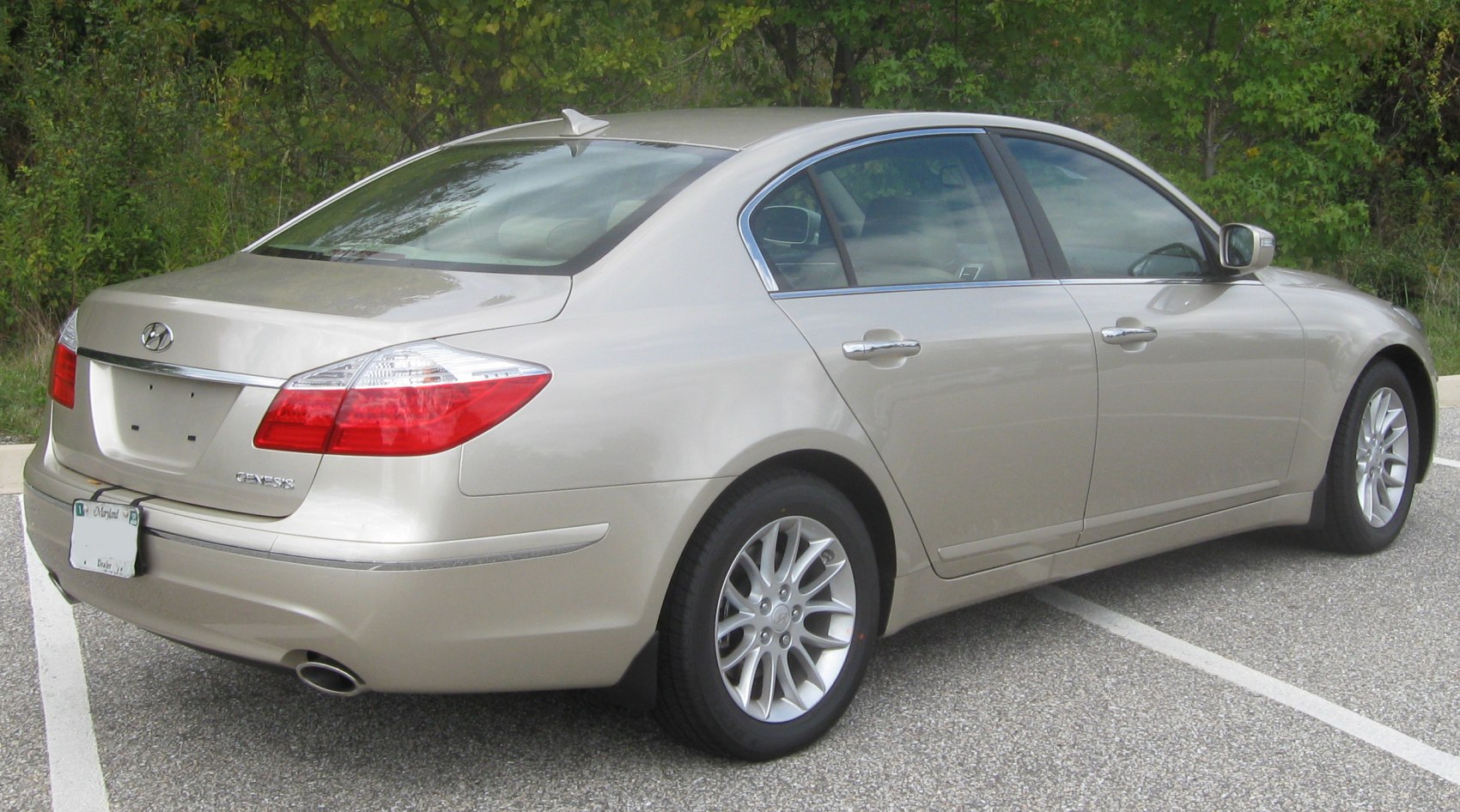 Rear and side view of luxury sedan with alloy wheels and chrome trim