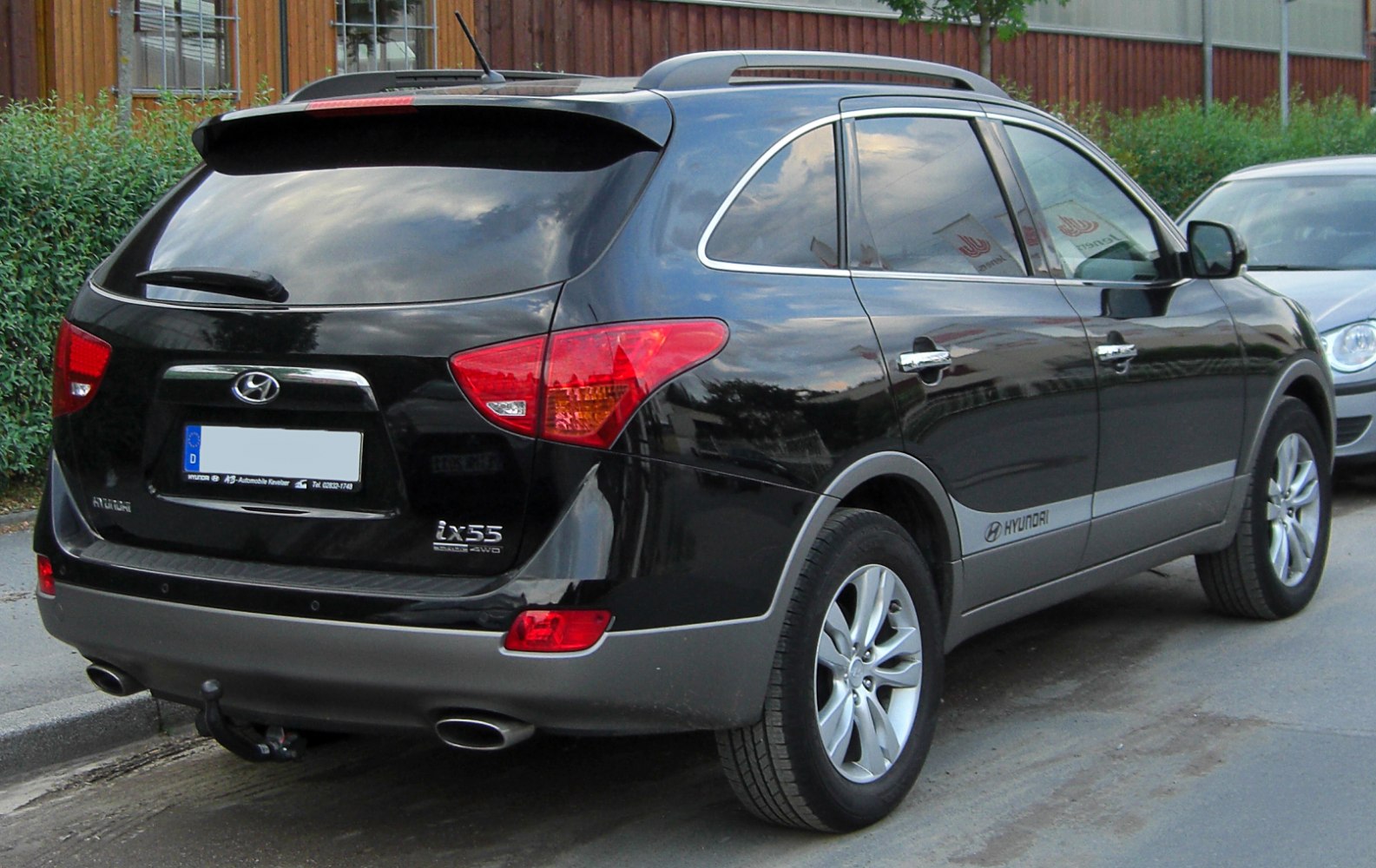 Rear view of SUV with distinctive tail lights and dual exhaust pipes