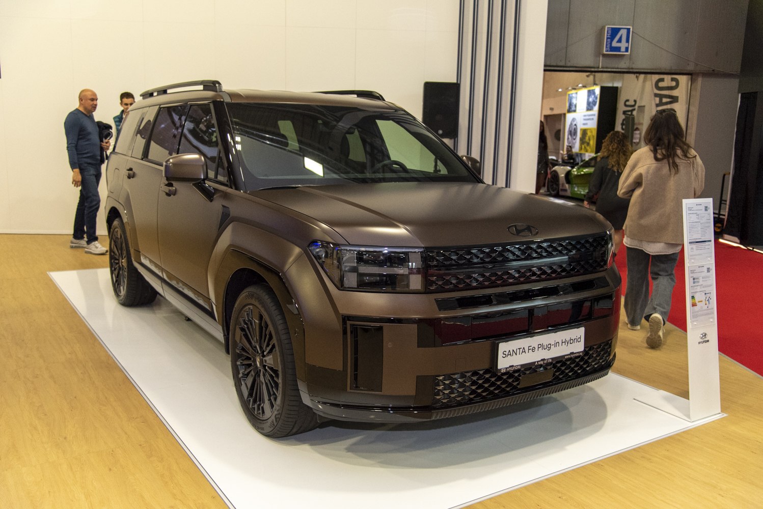 Front view of a large plug-in hybrid SUV with dark grille and sleek LED headlights