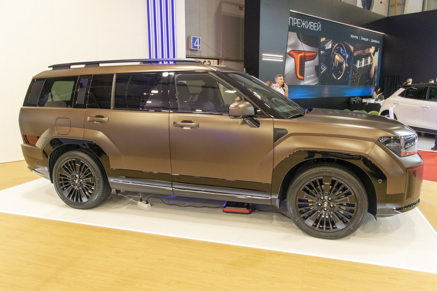 Side profile with black multi-spoke wheels of modern SUV