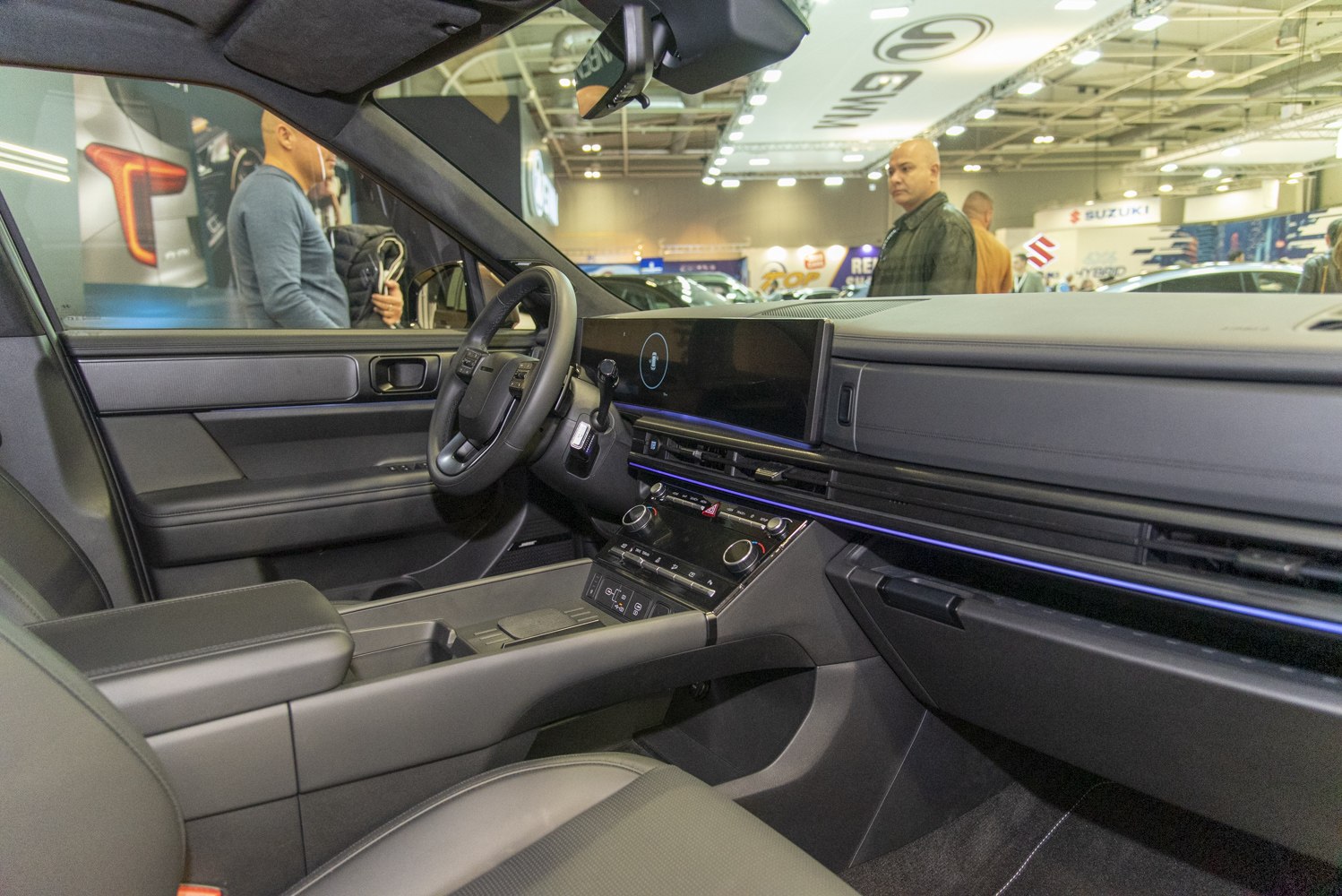 Modern SUV interior with digital displays and ambient lighting