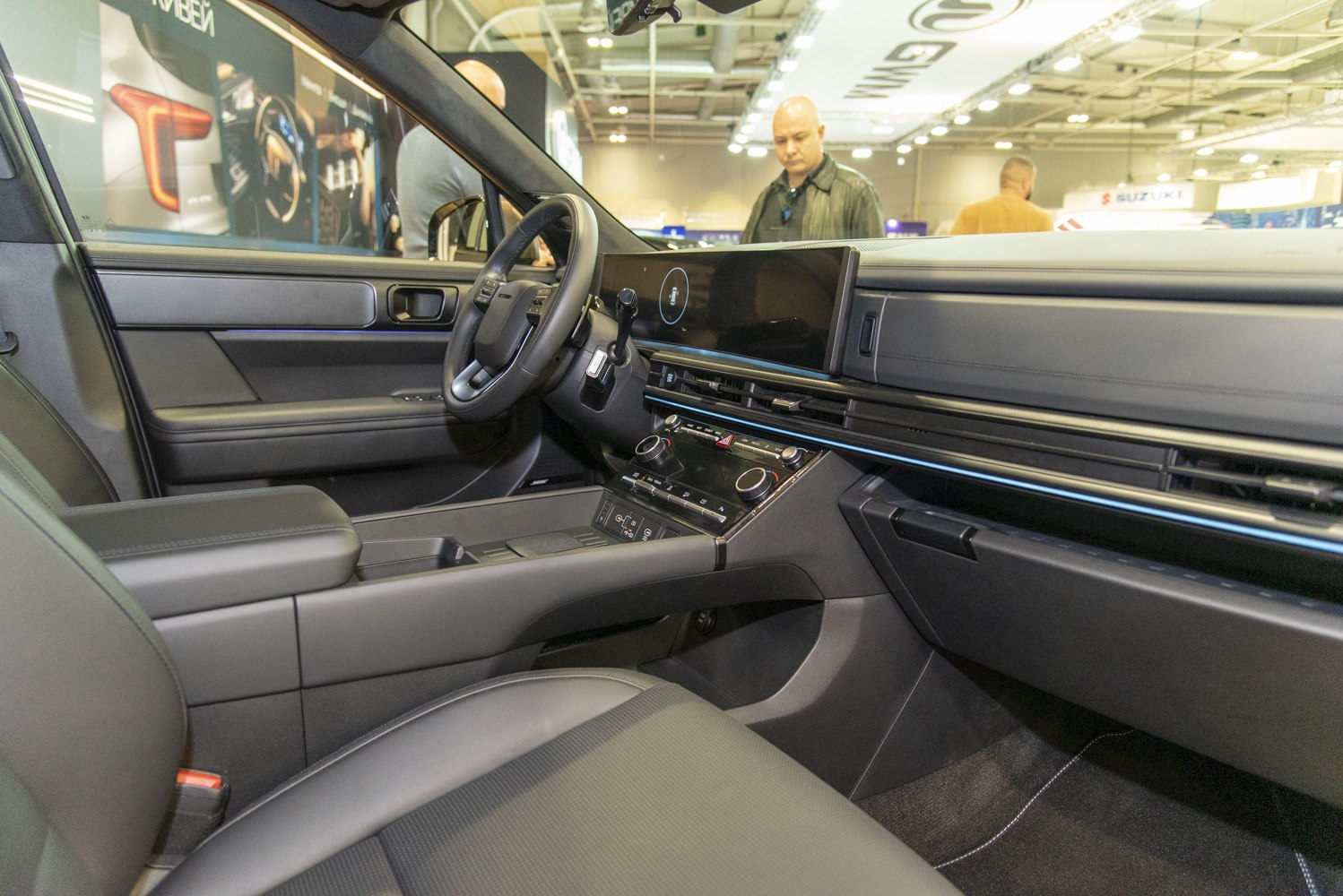 Modern car interior with dashboard and steering wheel.