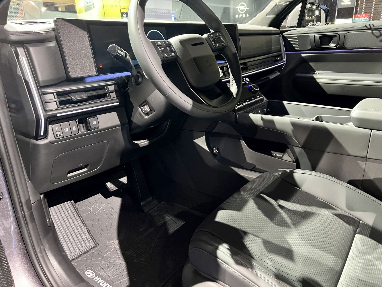 Dashboard, steering wheel, and center console with digital displays and modern controls