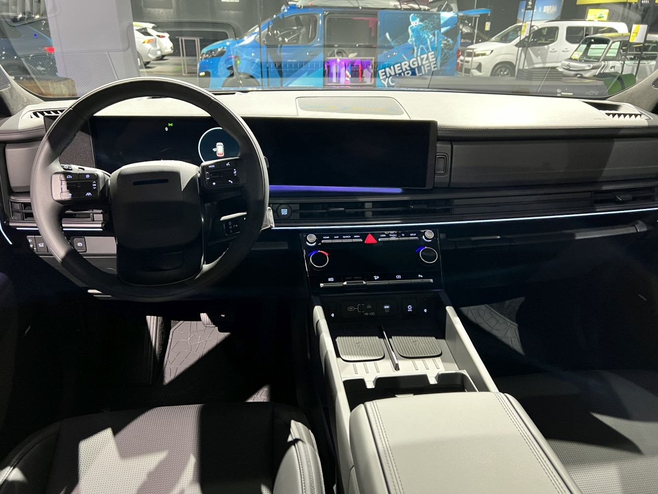 Modern dashboard with digital steering wheel and dual screens