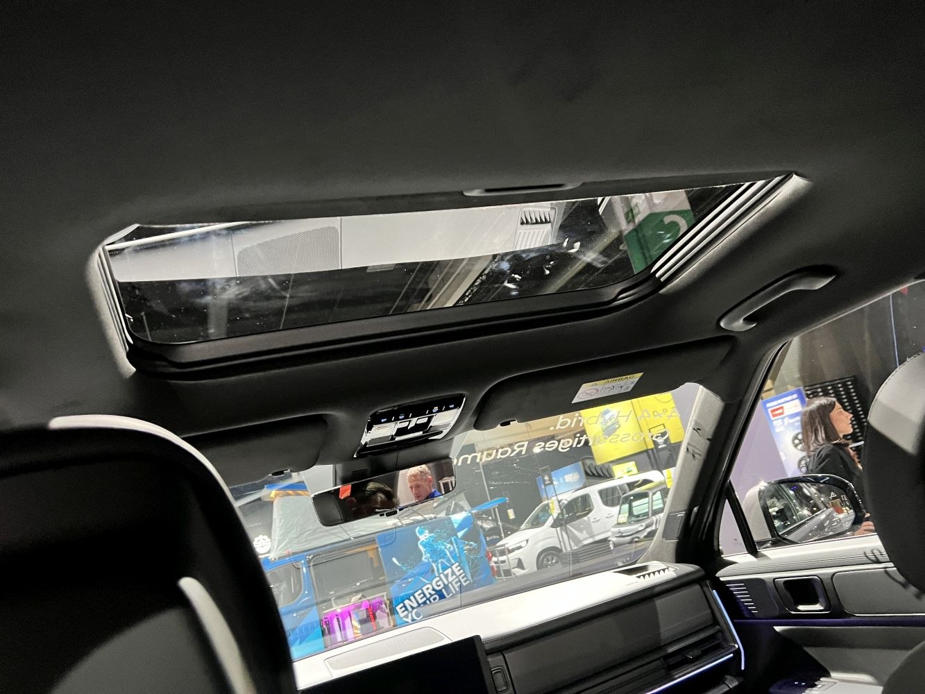 Panoramic sunroof and interior front cabin view.