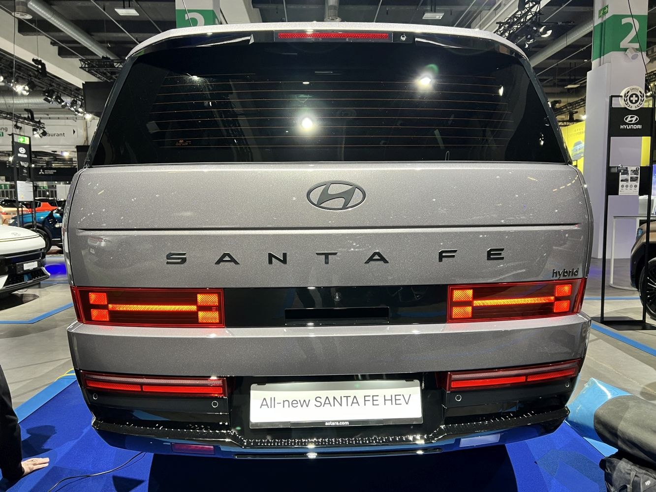 Rear LED tail lights and hybrid badge on modern SUV rear.