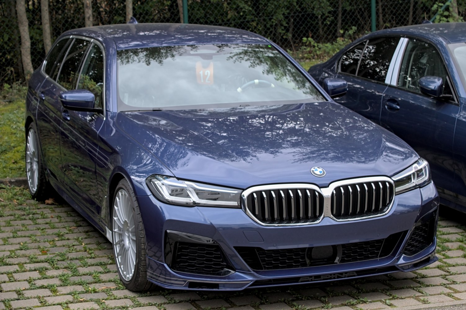 Luxury station wagon front view with kidney grille and LED headlights