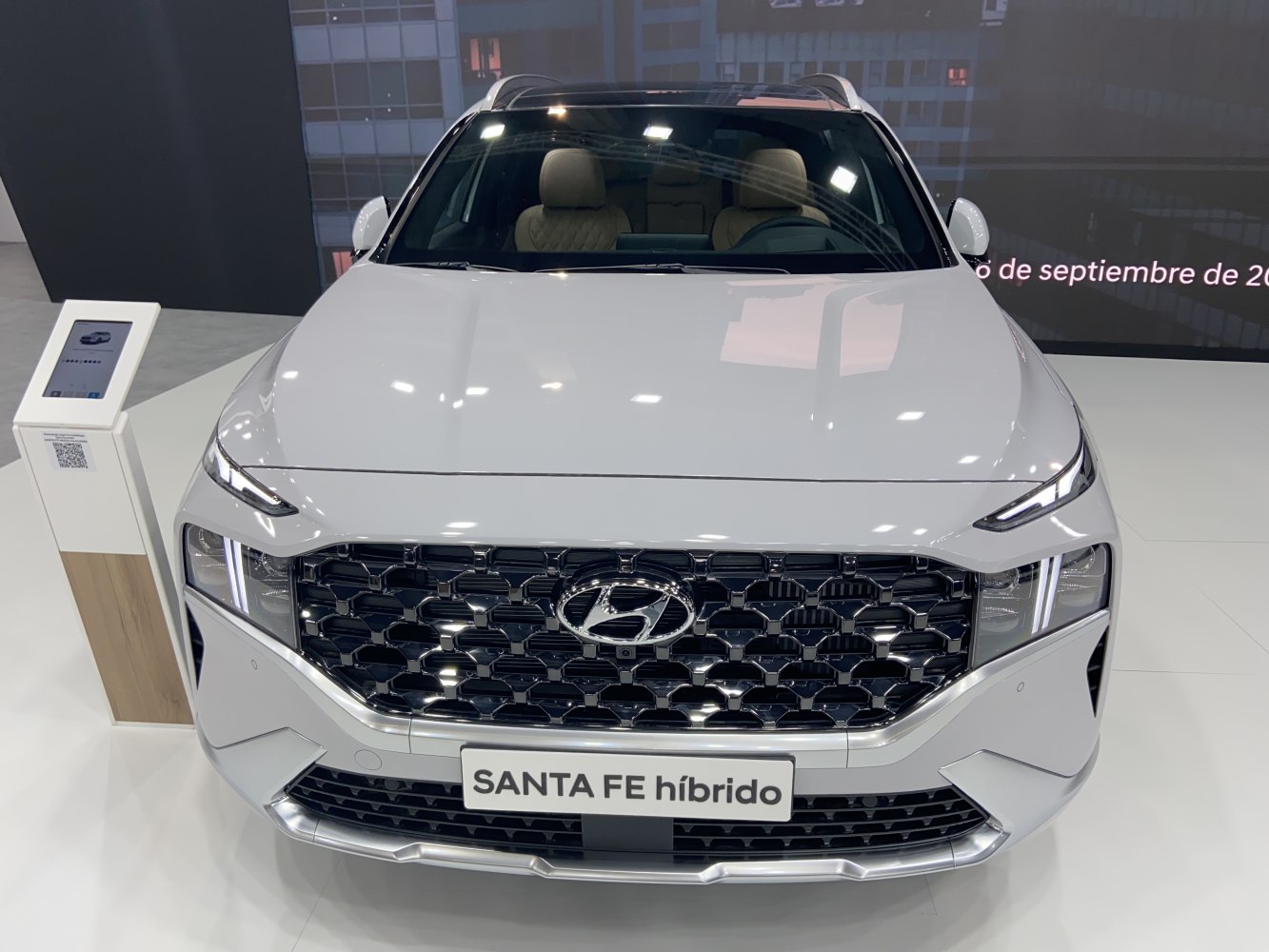 Close-up front grille and LED headlights with hybrid badge