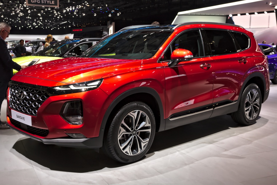 Red SUV with bold grille and LED headlights front three-quarter view