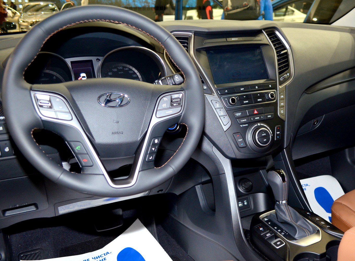 Steering wheel with controls and center console with touchscreen and gear shift