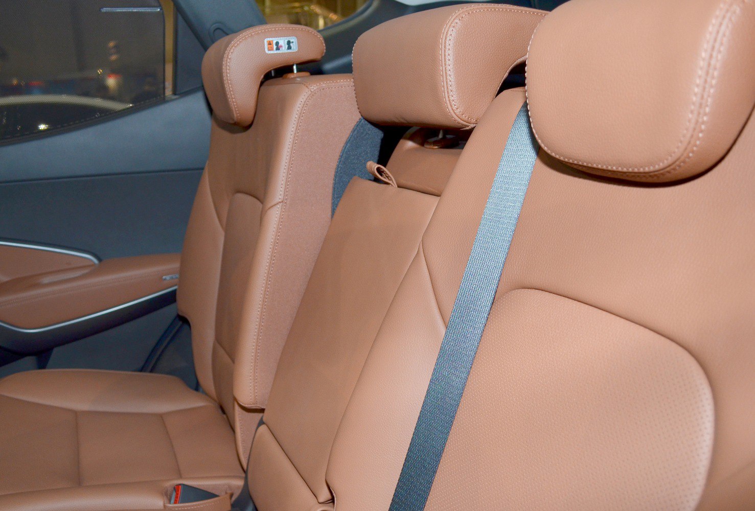 Brown leather rear seats with headrests and seat belts