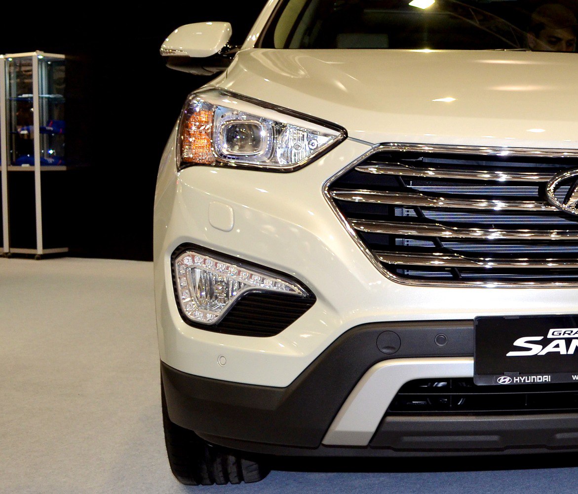 Close-up on front grille, headlight, and LED fog light of an SUV