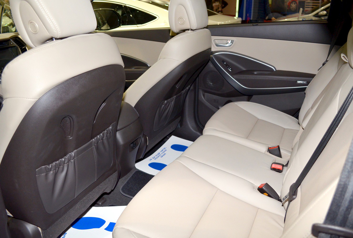 Spacious beige rear seat with back pockets and door panel design