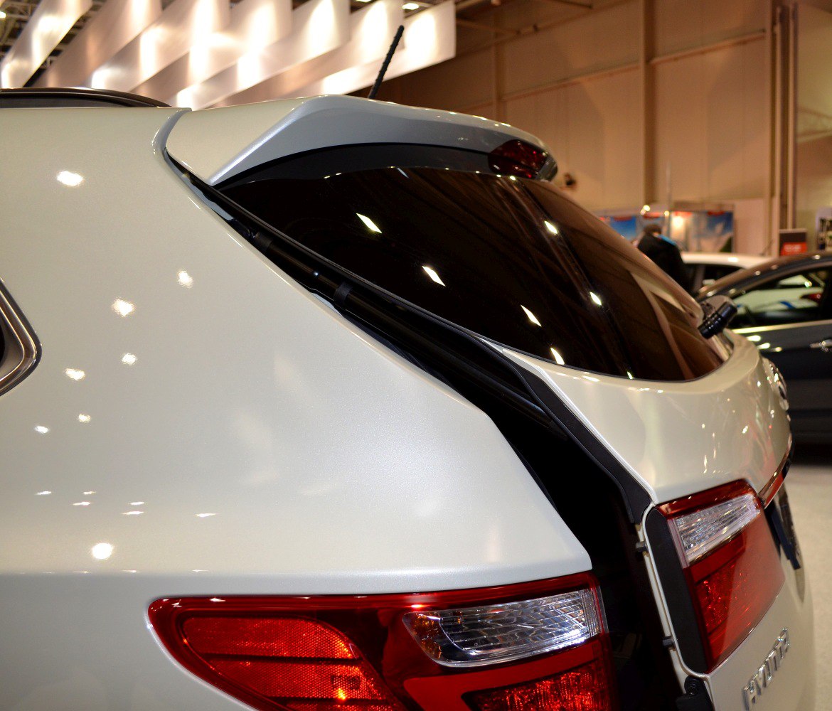 Rear tailgate with spoiler and integrated tail light