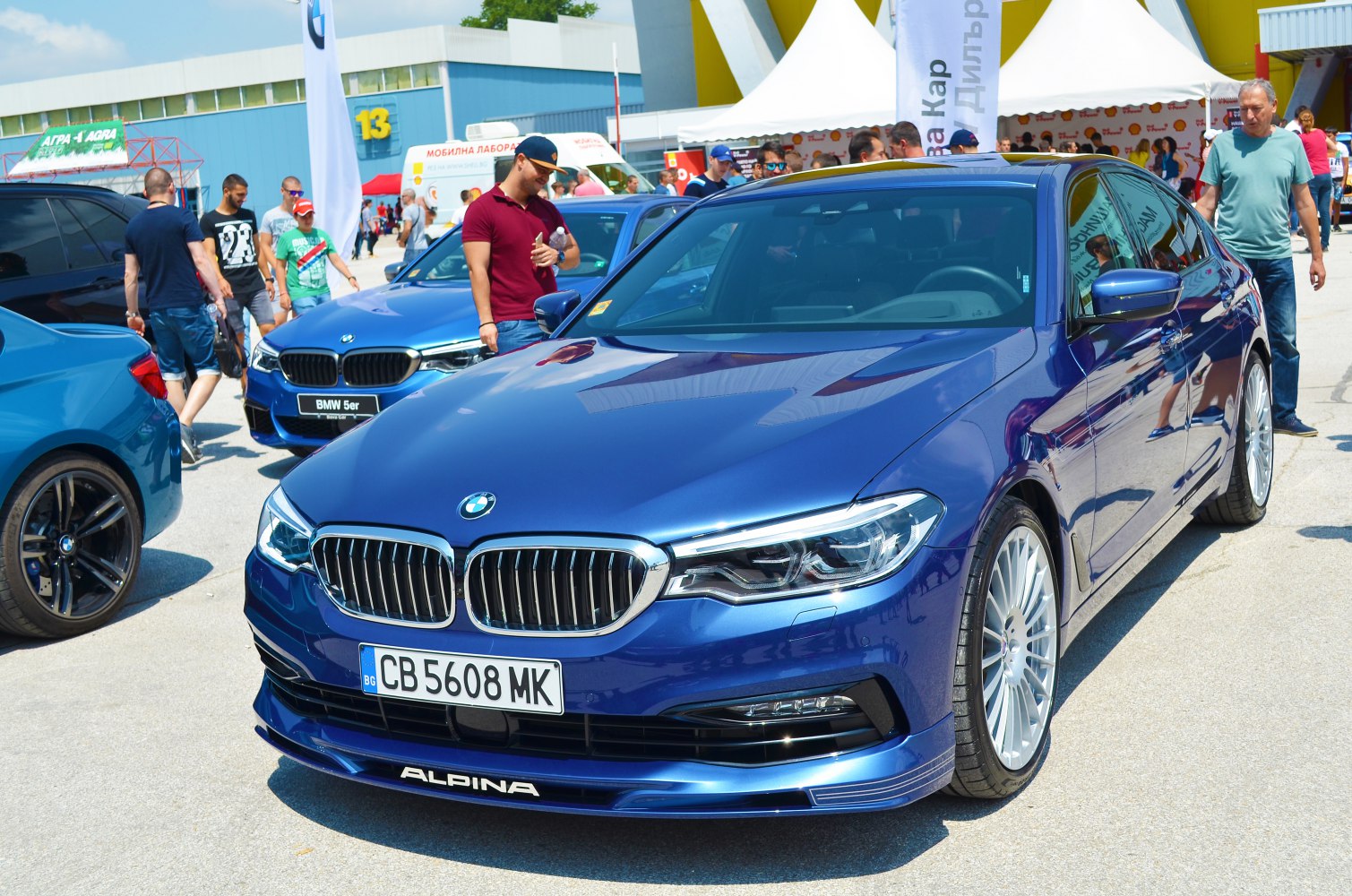 Luxury sedan front and side view with distinctive alloy wheels