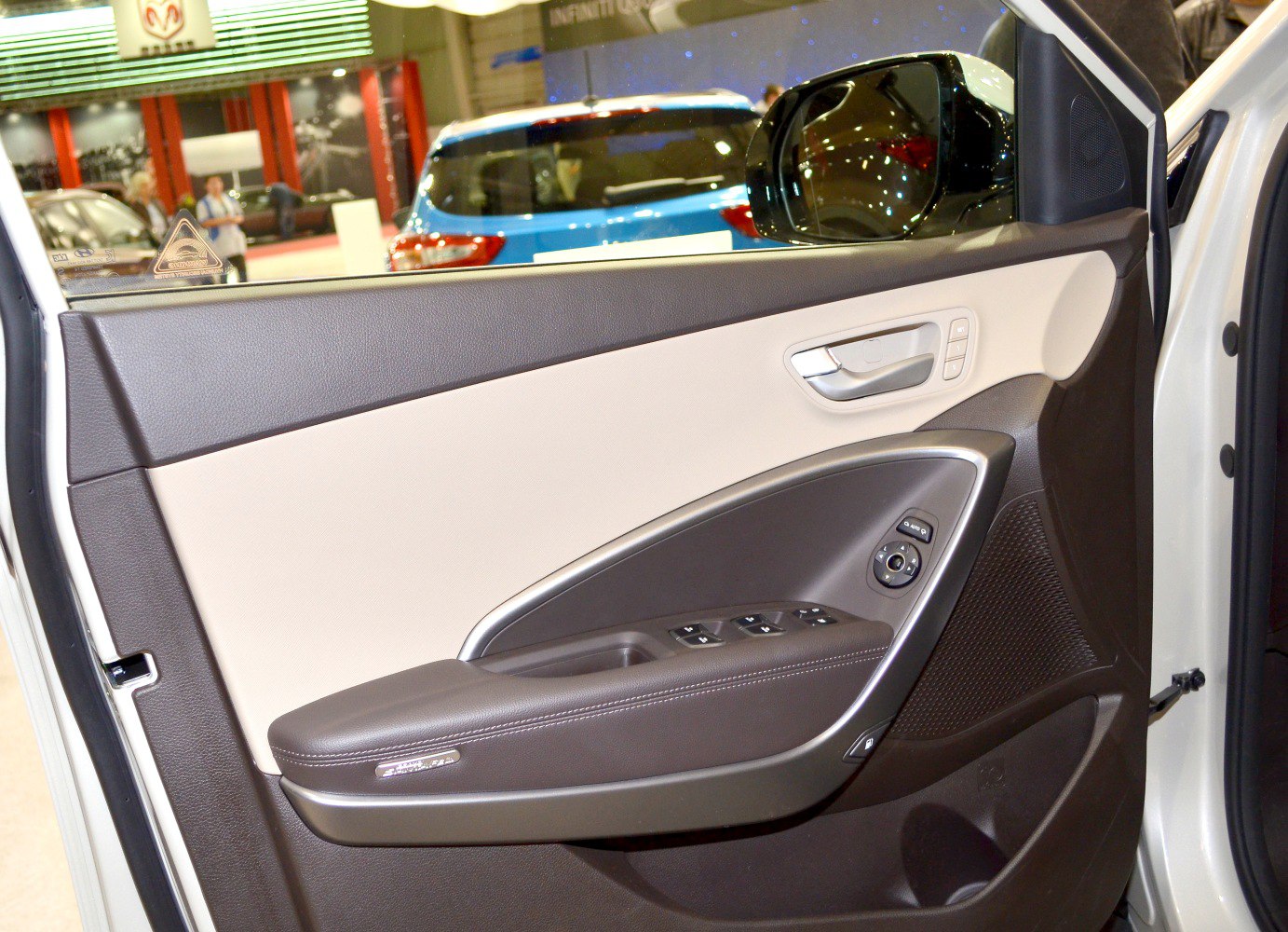 Interior door panel with ergonomic controls and modern design